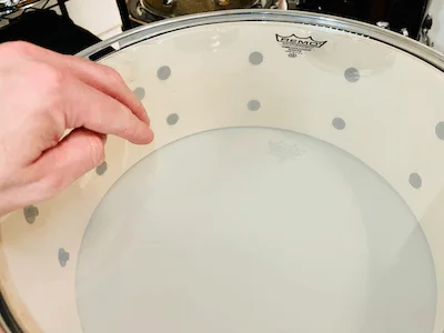 checking bottom snare head tension